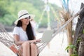 Lifestyle freelance woman using smartphone working and shopping on the beach. Royalty Free Stock Photo